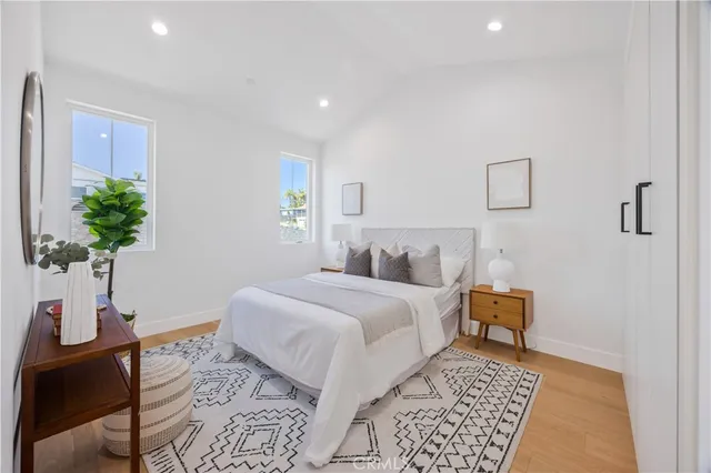 a bedroom with a bed and wooden floor