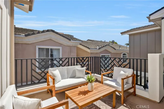 a balcony with chairs and glass door