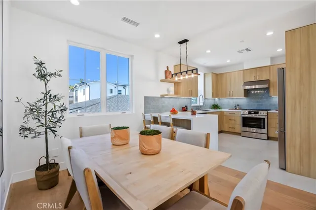 a view of a dining room with furniture and chandelier
