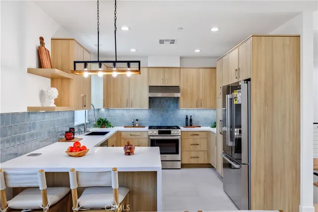 a kitchen with a sink a stove and cabinets