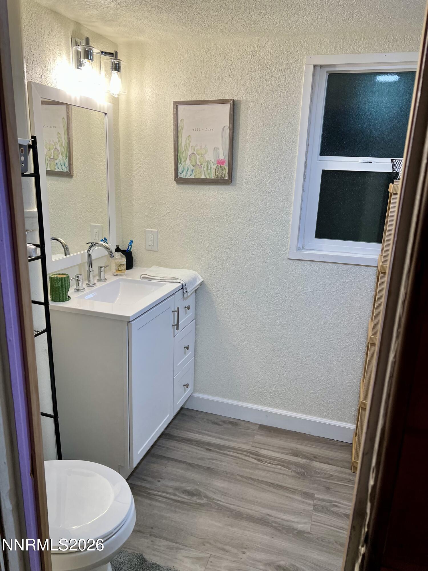 745 West Center Street Fallon, NV 89406 - Photo 7 of 23 a bathroom with a sink mirror vanity and toilet