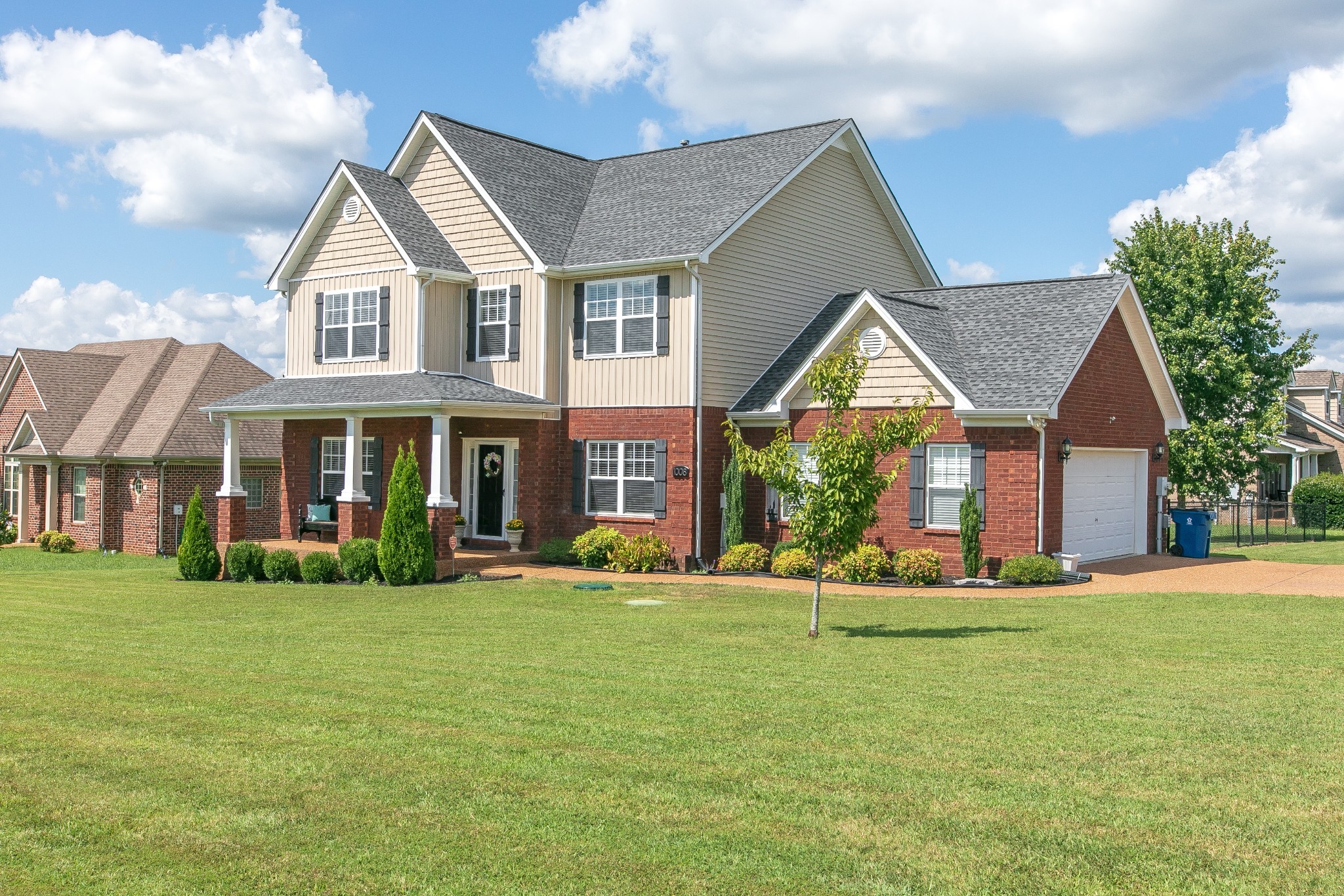 a front view of brick house with a yard