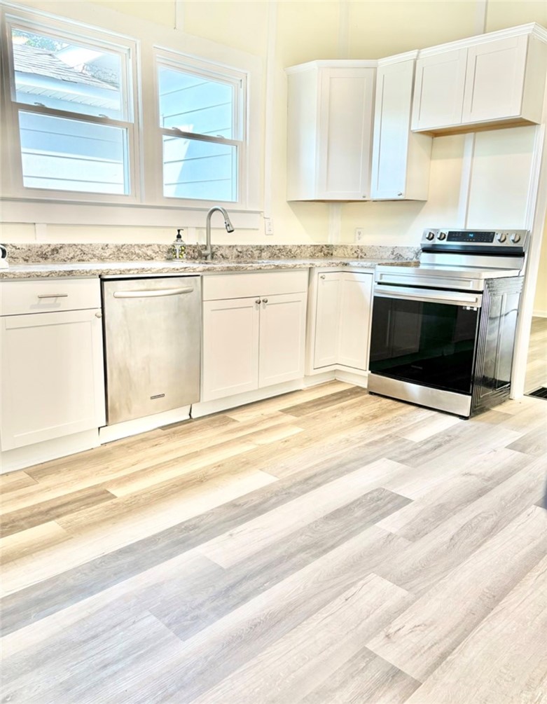 208 Hampton Street Iva, SC 29655 - Photo 4 of 19 This bright kitchen features modern appliances and ample counter space.