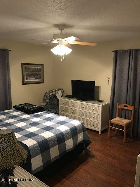 97076 Benchmark Avenue Yulee, FL 32097 - Photo 8 of 13 a bedroom with a bed and a window