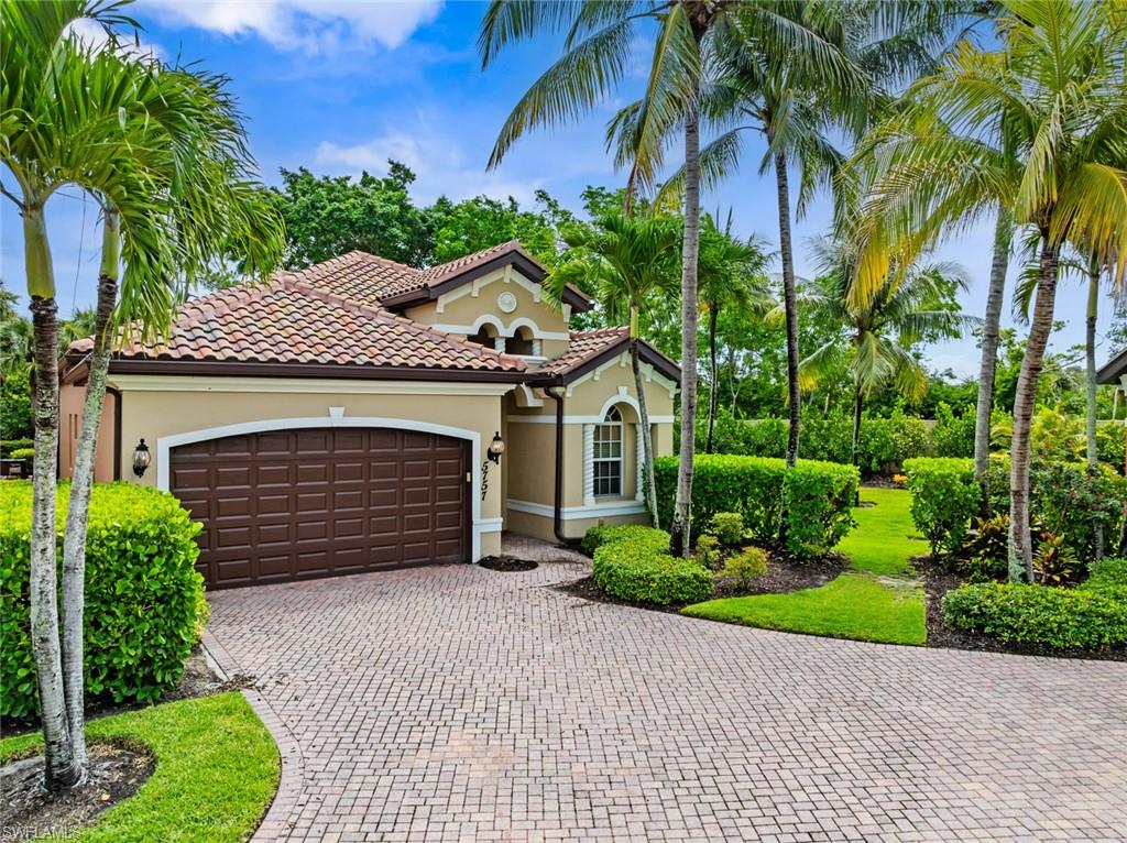 5757 Mango Circle Naples, FL 34110 - Photo 1 of 38 a front view of a house with a yard