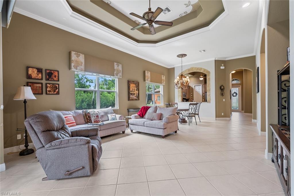 5757 Mango Circle Naples, FL 34110 - Photo 11 of 38 a living room with furniture and a large window