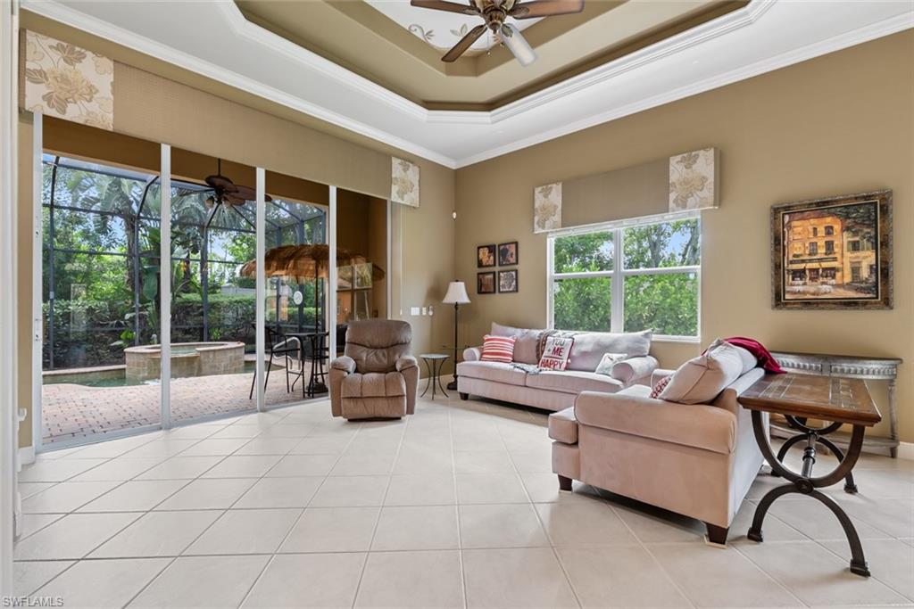 5757 Mango Circle Naples, FL 34110 - Photo 12 of 38 a living room with furniture and a large window