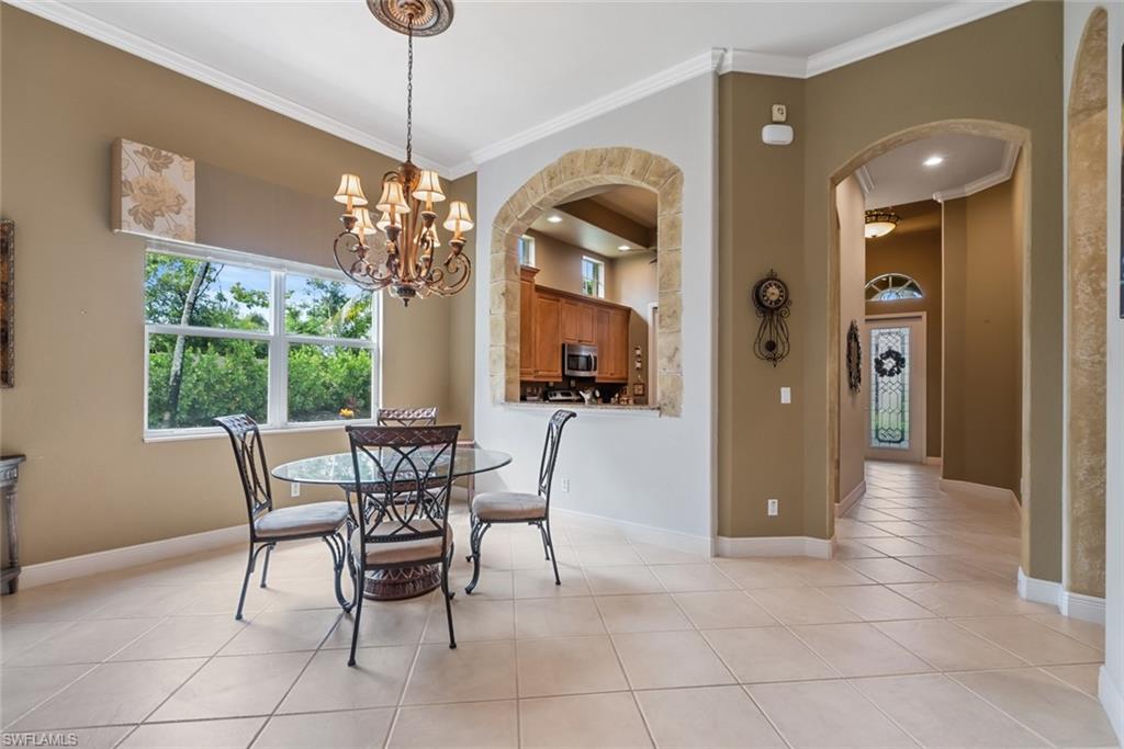 5757 Mango Circle Naples, FL 34110 - Photo 15 of 38 a view of a dining room with furniture window and outside view