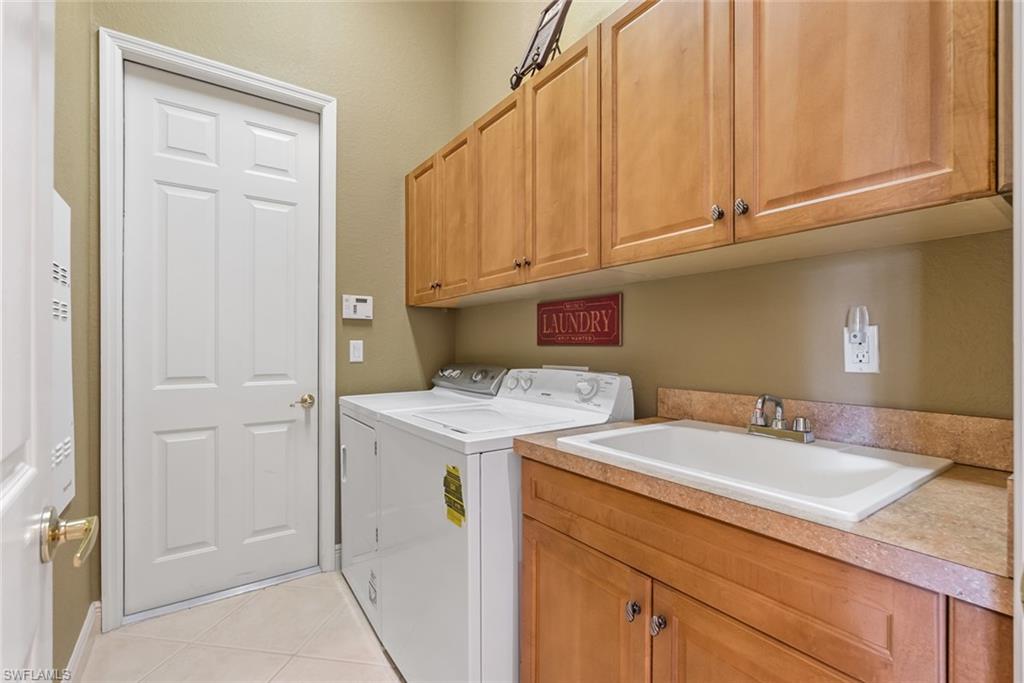 5757 Mango Circle Naples, FL 34110 - Photo 24 of 38 a utility room with sink dryer and washer