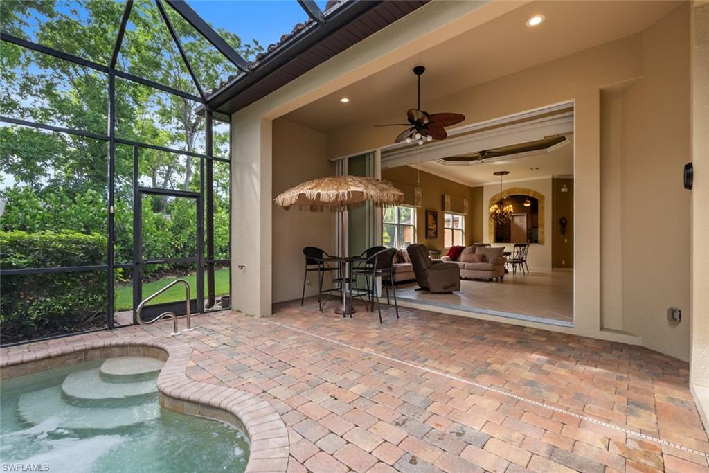 5757 Mango Circle Naples, FL 34110 - Photo 26 of 38 a view of a porch with chairs and backyard