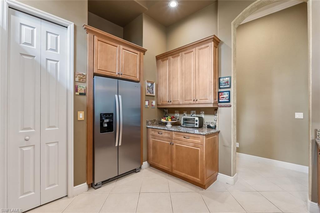 5757 Mango Circle Naples, FL 34110 - Photo 4 of 38 a kitchen with stainless steel appliances granite countertop a refrigerator and a sink