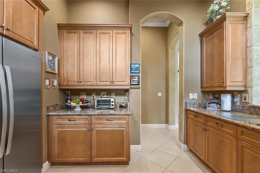 5757 Mango Circle Naples, FL 34110 - Photo 6 of 38 a kitchen with stainless steel appliances granite countertop a refrigerator sink and cabinets