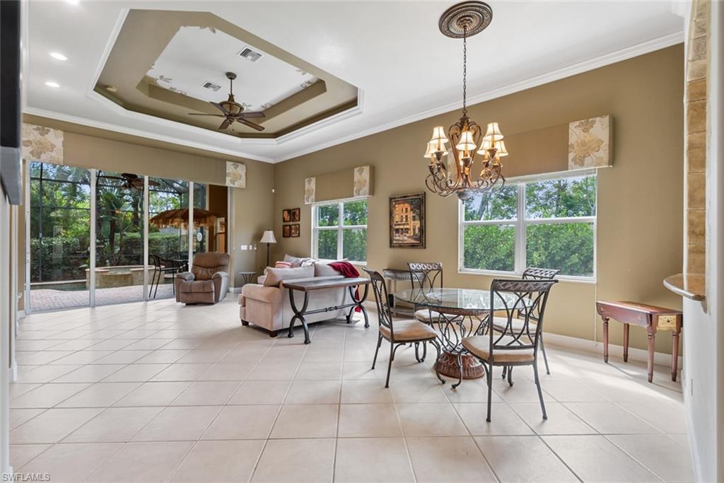 5757 Mango Circle Naples, FL 34110 - Photo 10 of 38 a view of a dining room with furniture wooden floor and chandelier