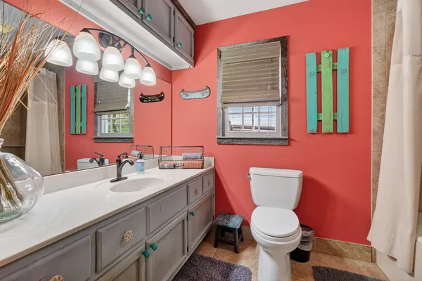 a bathroom with a toilet sink and mirror