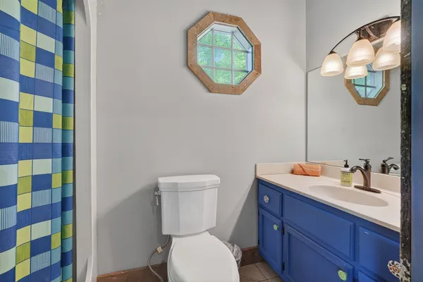 a bathroom with a toilet a sink and mirror