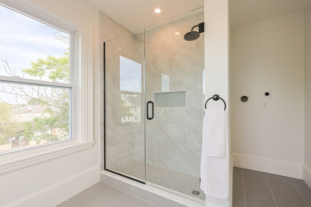 179 B Main Street, Unit B Medford, MA 02155 - Photo 19 of 40 a bathroom with a shower and a window