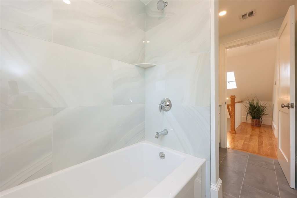 179 B Main Street, Unit B Medford, MA 02155 - Photo 25 of 40 a bathroom with a bathtub and a shower