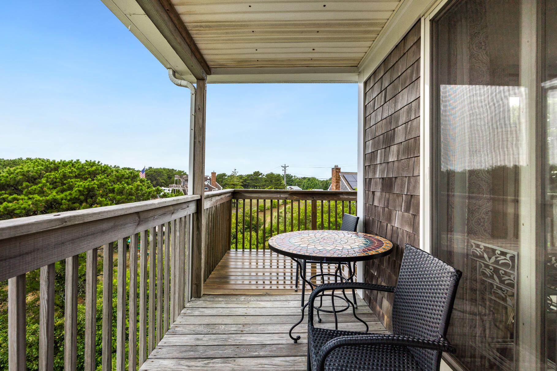 132 Shore Road, Unit 30 Truro, MA 02666 - Photo 16 of 32 a view of a balcony with a table and chairs