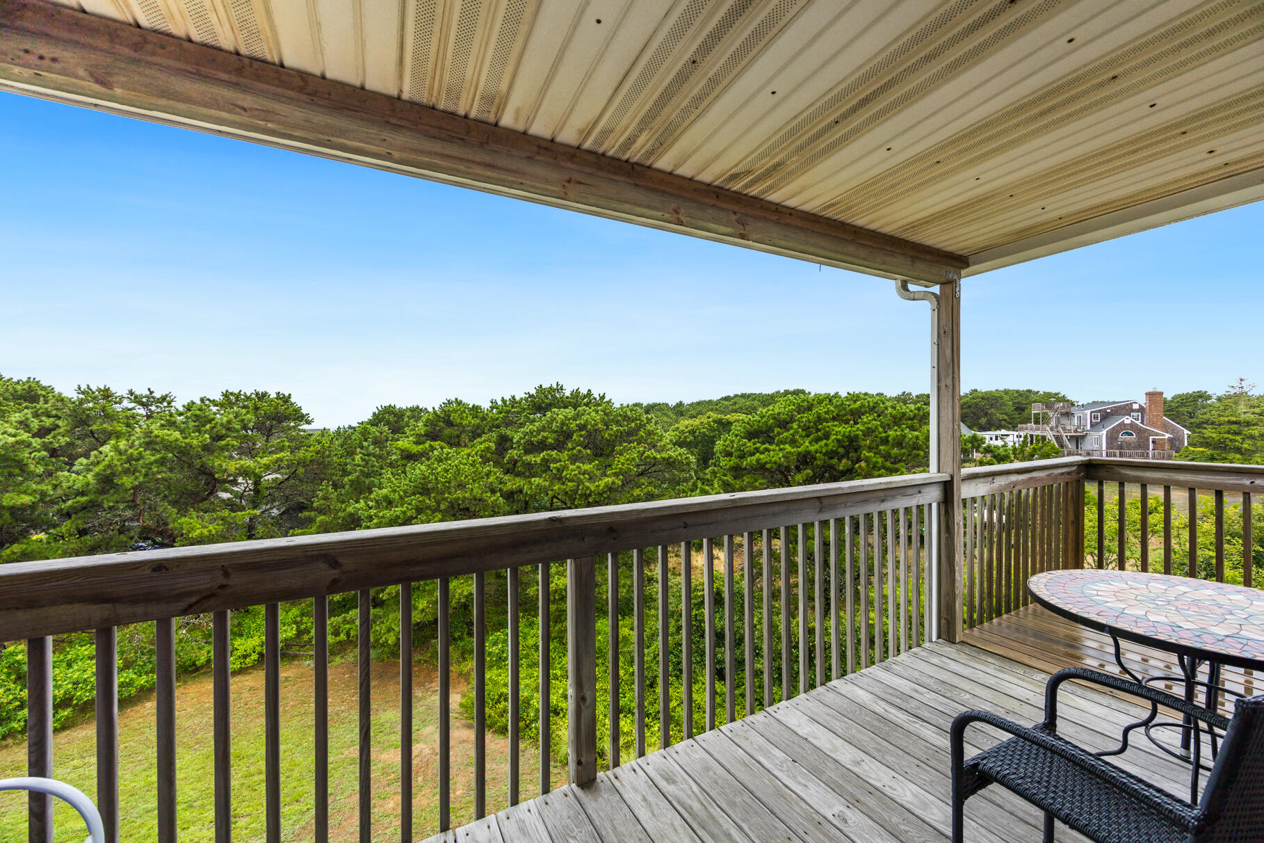 132 Shore Road, Unit 30 Truro, MA 02666 - Photo 18 of 32 a view of a balcony with wooden floor and outdoor seating