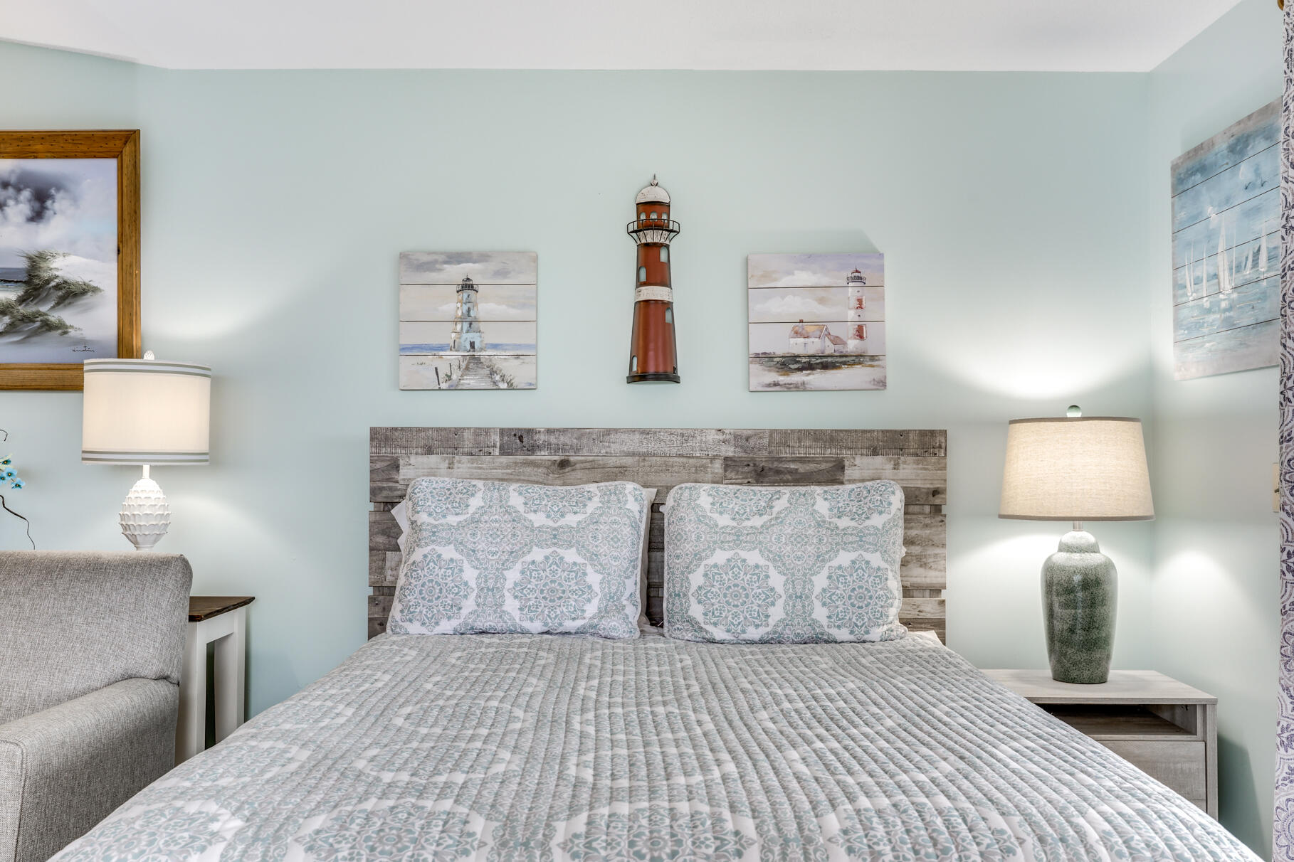 132 Shore Road, Unit 30 Truro, MA 02666 - Photo 25 of 32 a bedroom with a bed and a lamp