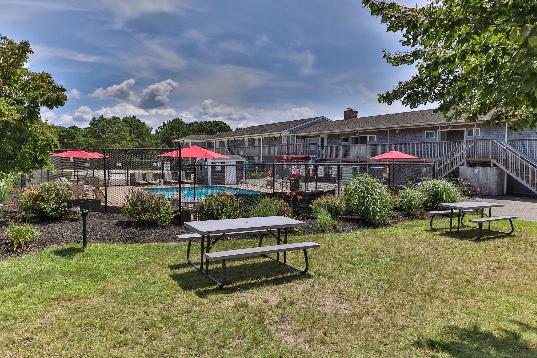 132 Shore Road, Unit 30 Truro, MA 02666 - Photo 26 of 32 a view of a chairs and table in a backyard