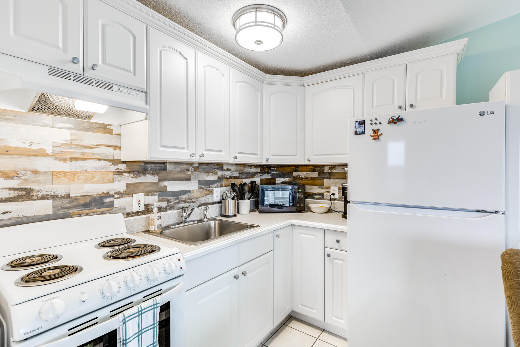 132 Shore Road, Unit 30 Truro, MA 02666 - Photo 9 of 32 a white refrigerator freezer sitting inside of a kitchen