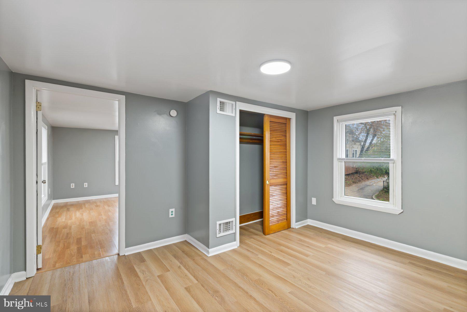 3700 7th Street Baltimore, MD 21225 - Photo 14 of 25 an empty room with wooden floor and windows