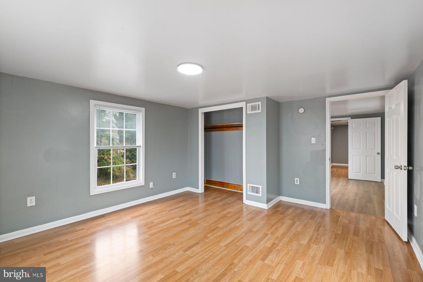 3700 7th Street Baltimore, MD 21225 - Photo 17 of 25 wooden floor in an empty room with a window