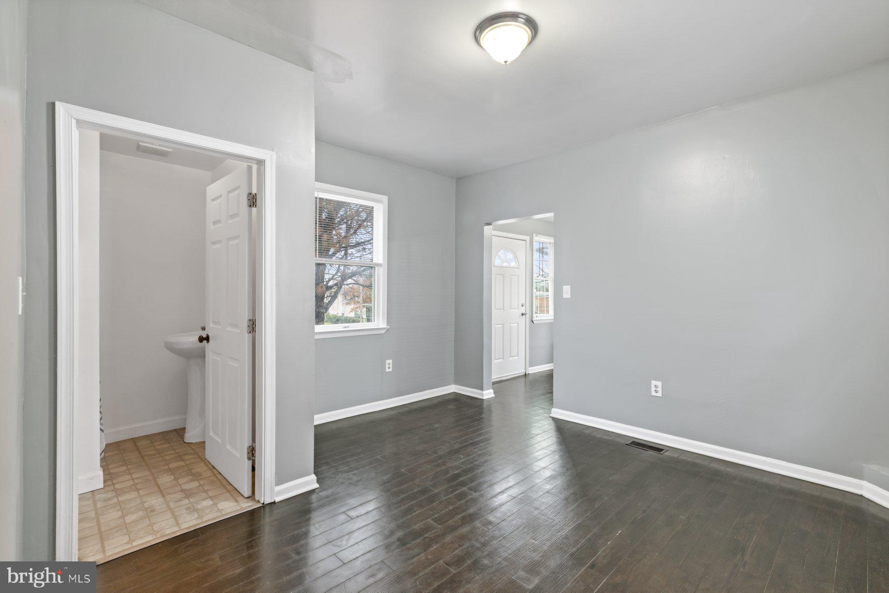 3700 7th Street Baltimore, MD 21225 - Photo 21 of 25 an empty room with wooden floor and windows