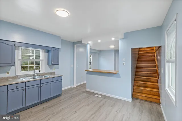 a view of a kitchen with a sink and windows