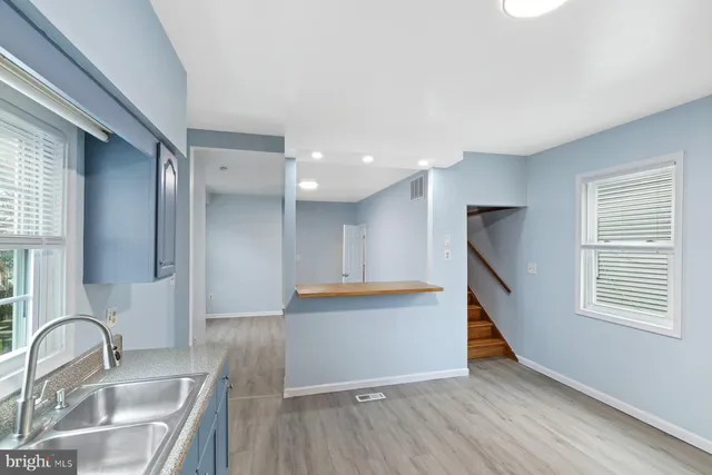 a kitchen with granite countertop a sink and a stove top oven