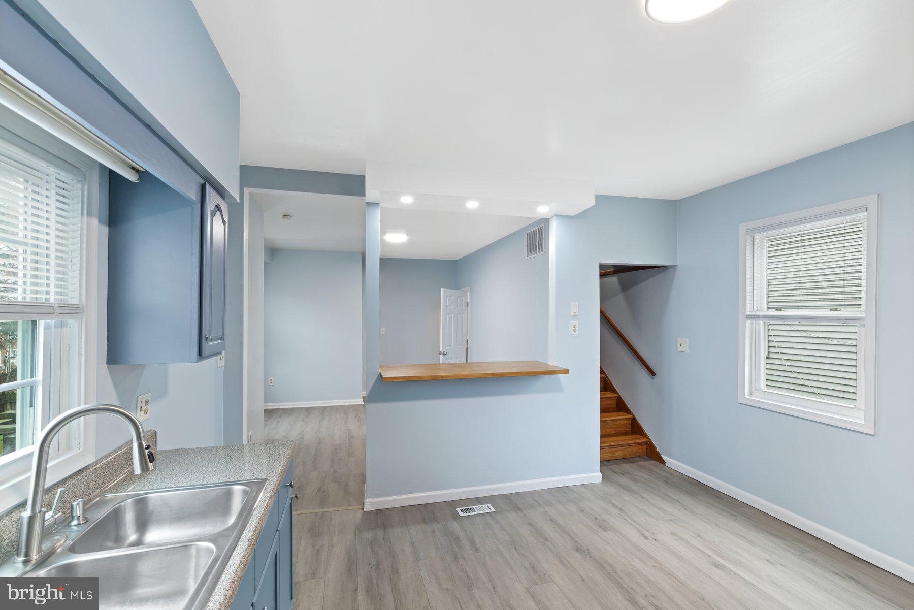 3700 7th Street Baltimore, MD 21225 - Photo 8 of 25 a kitchen with granite countertop a sink and a stove top oven