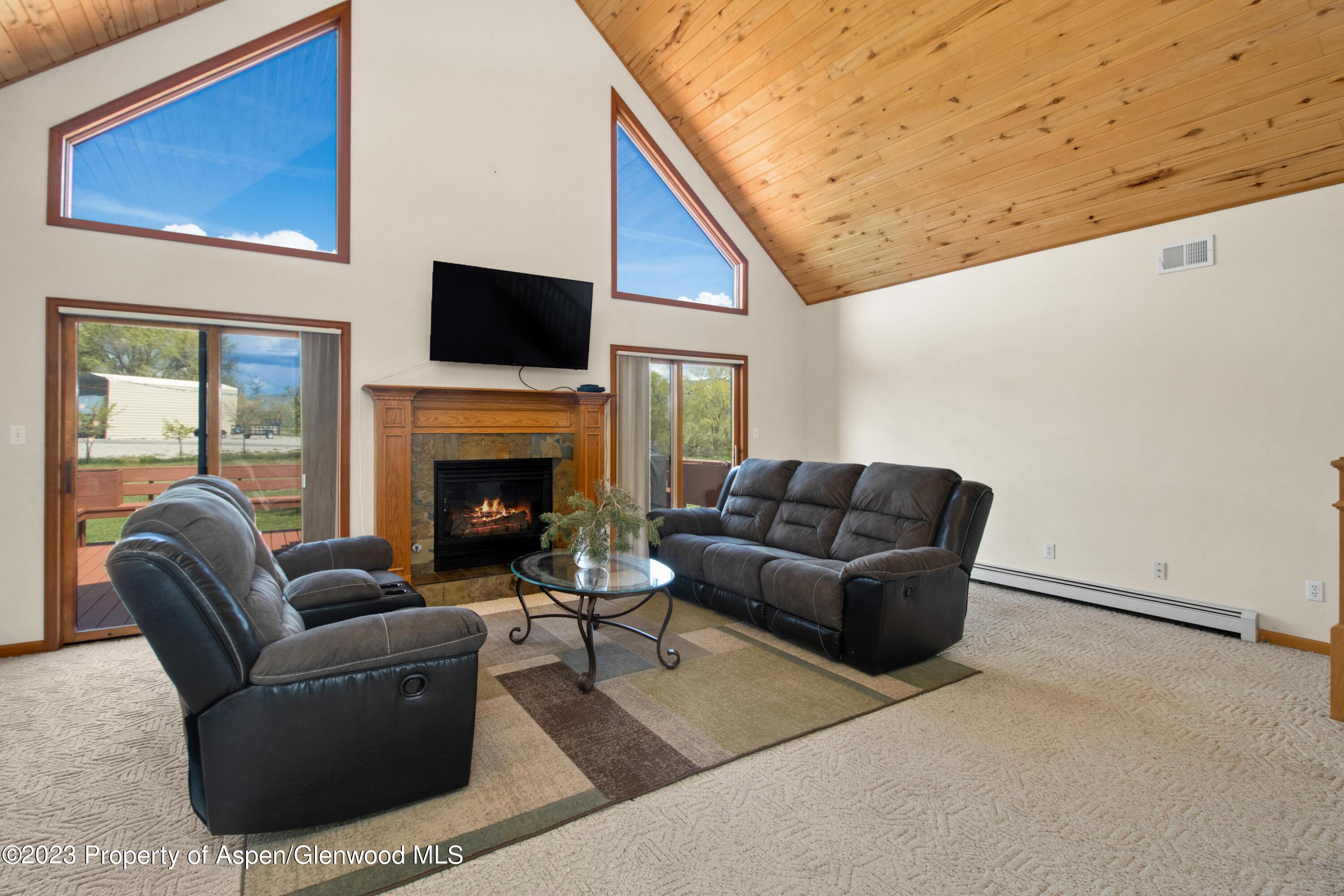 1840 County Road 293 Rifle, CO 81650 - Photo 12 of 27 a living room with furniture a flat screen tv and a fireplace