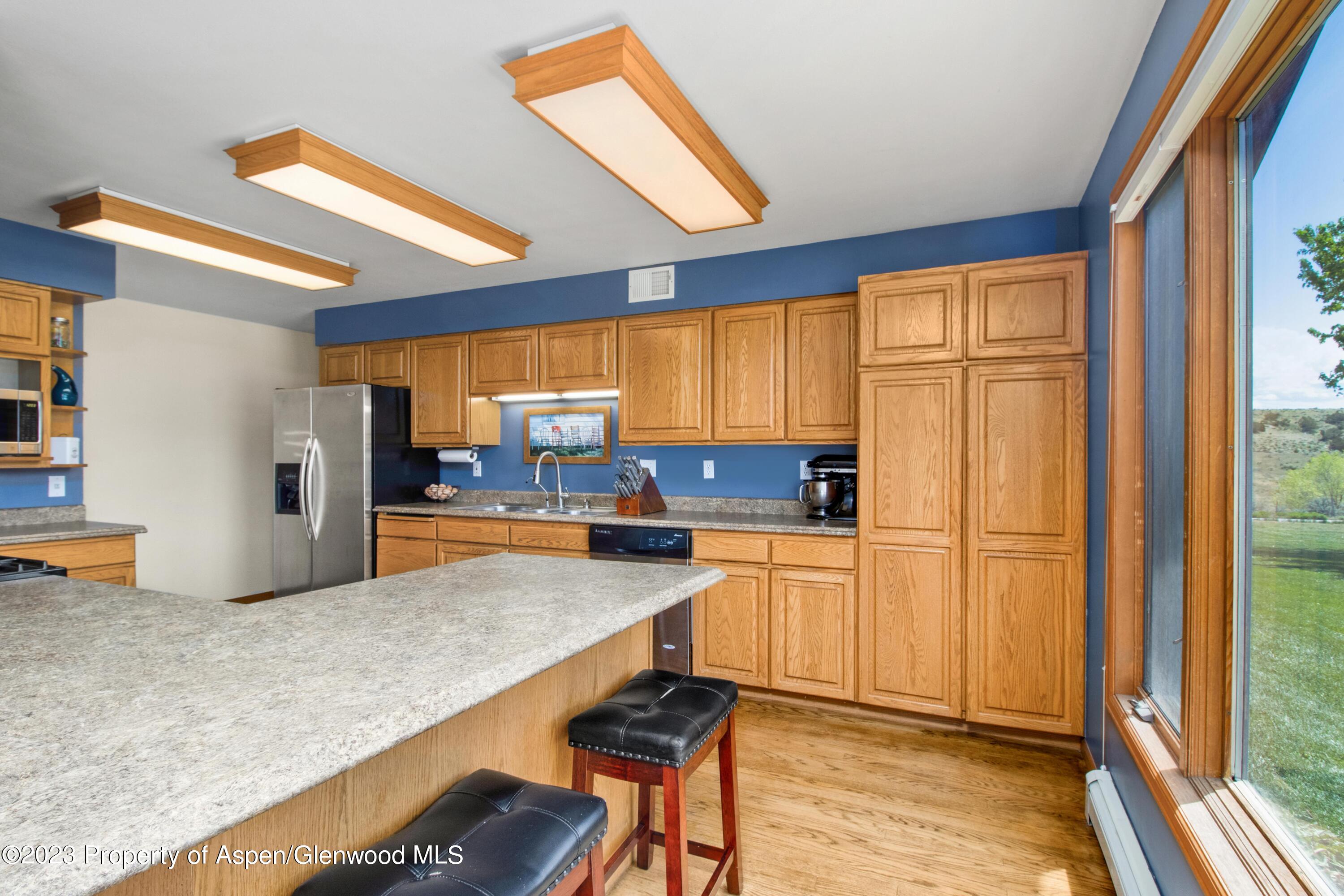 1840 County Road 293 Rifle, CO 81650 - Photo 16 of 27 a kitchen with stainless steel appliances granite countertop a refrigerator and wooden cabinets