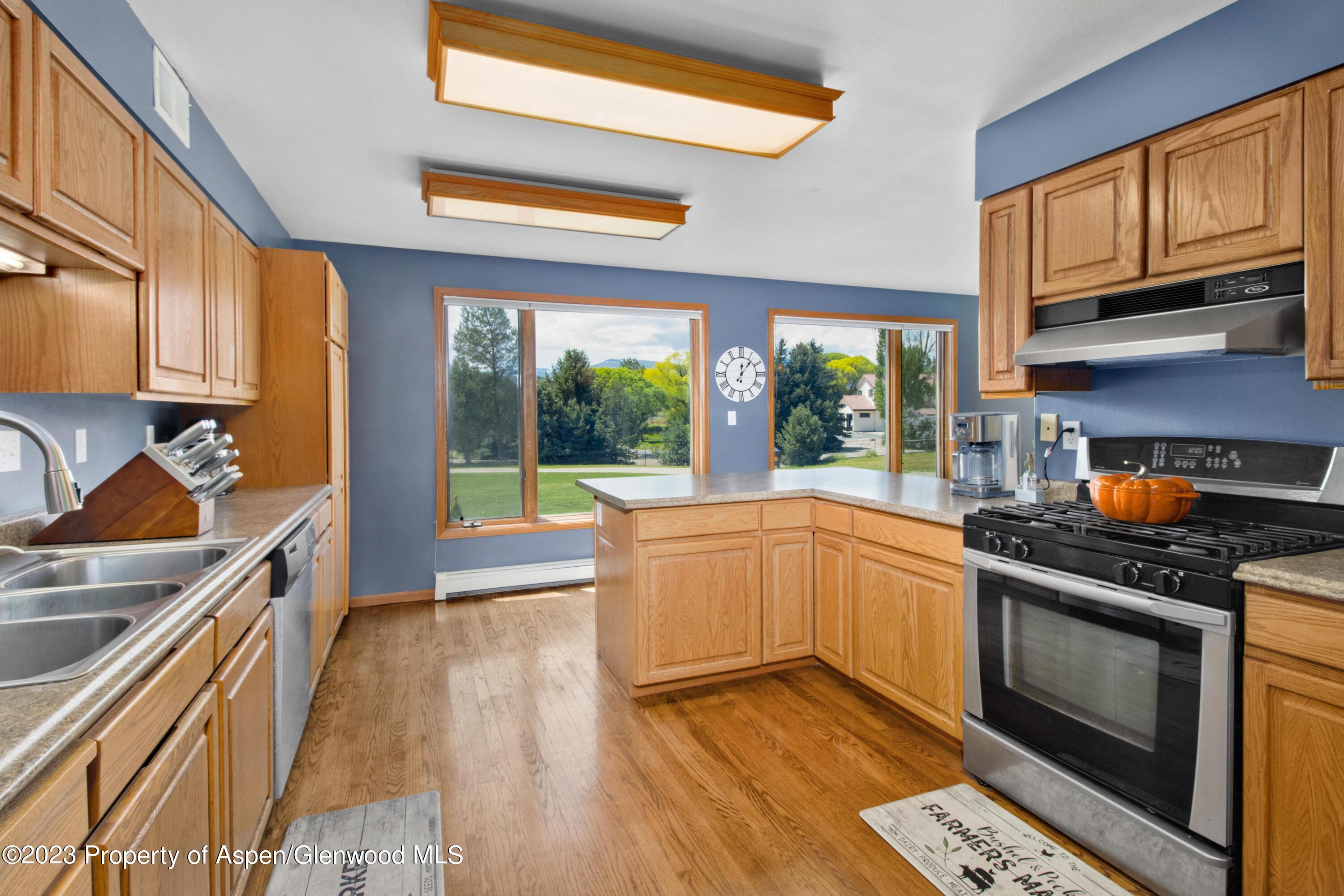 1840 County Road 293 Rifle, CO 81650 - Photo 17 of 27 a kitchen with stainless steel appliances granite countertop a stove a sink and a microwave