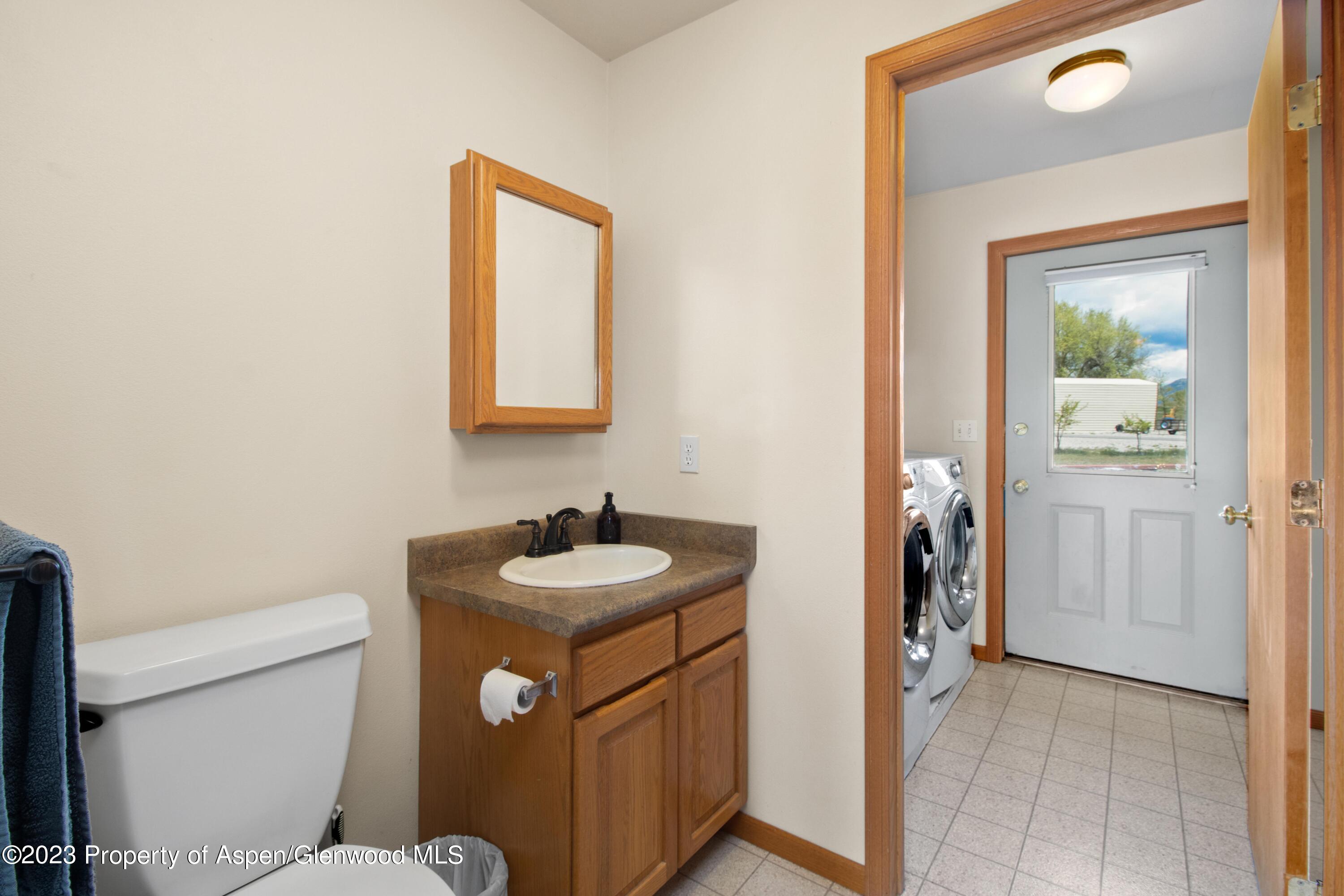 1840 County Road 293 Rifle, CO 81650 - Photo 23 of 27 a bathroom with a toilet sink vanity and mirror
