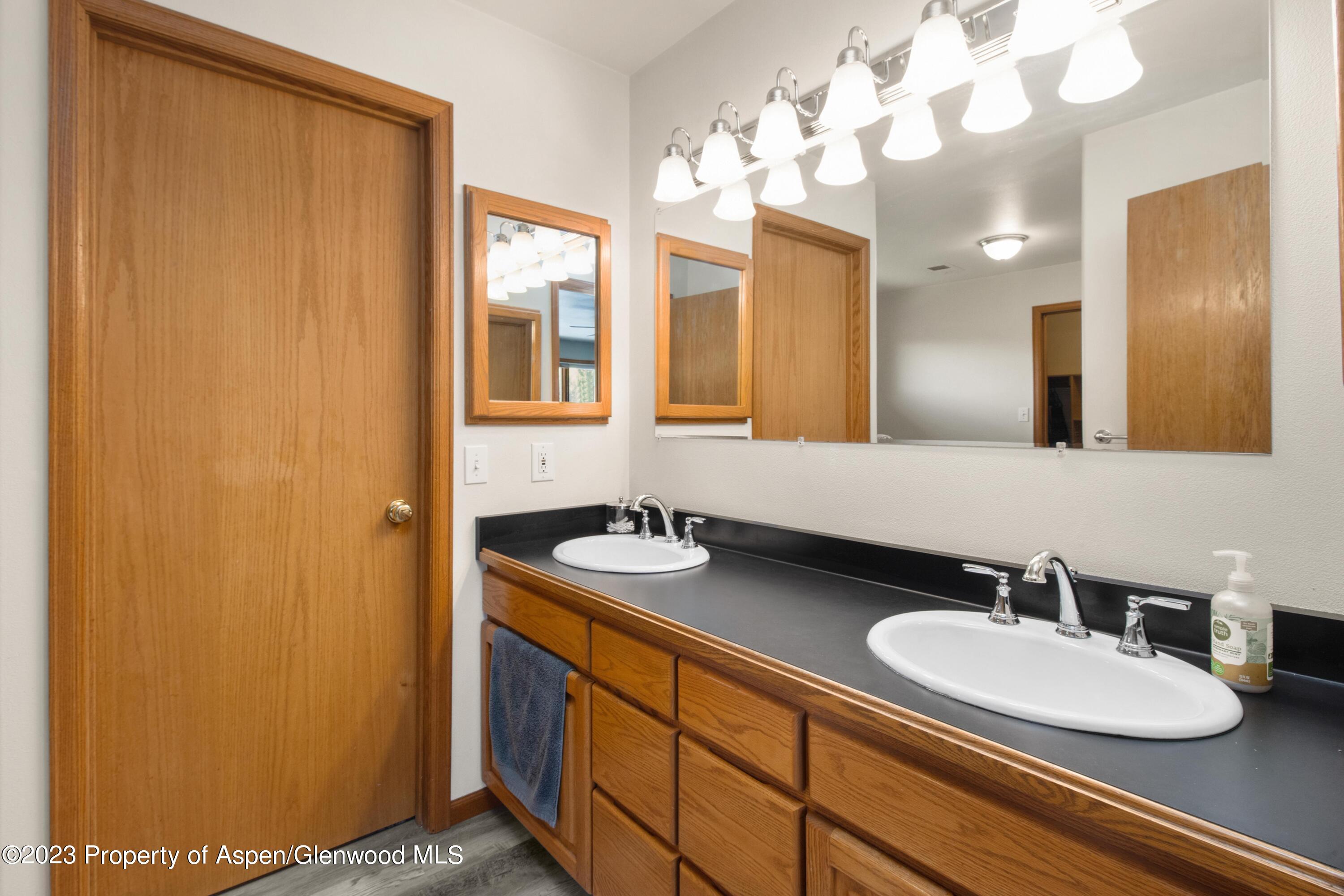 1840 County Road 293 Rifle, CO 81650 - Photo 25 of 27 a bathroom with a sink and a mirror