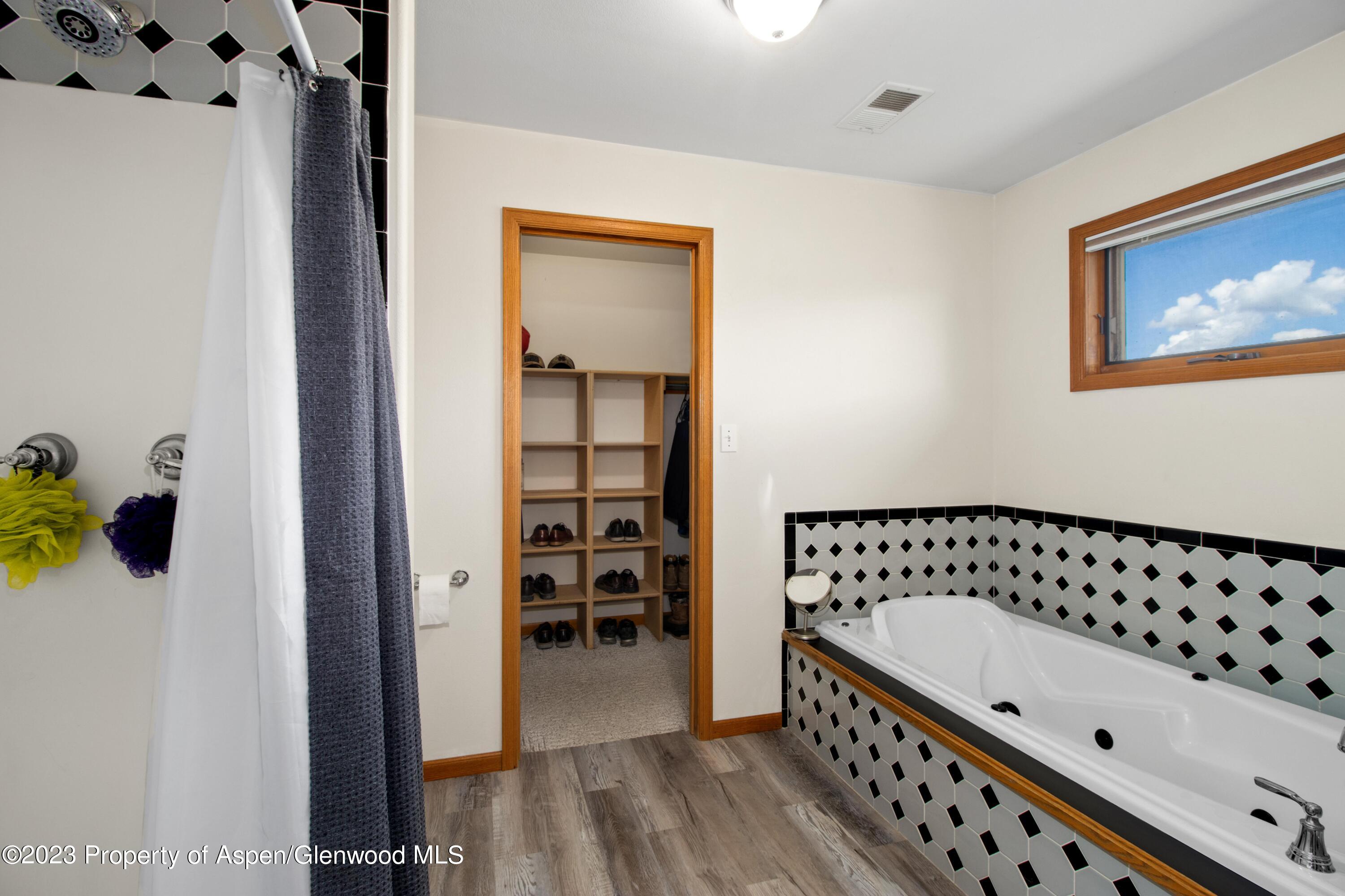 1840 County Road 293 Rifle, CO 81650 - Photo 26 of 27 a bathroom with a bathtub and a shower