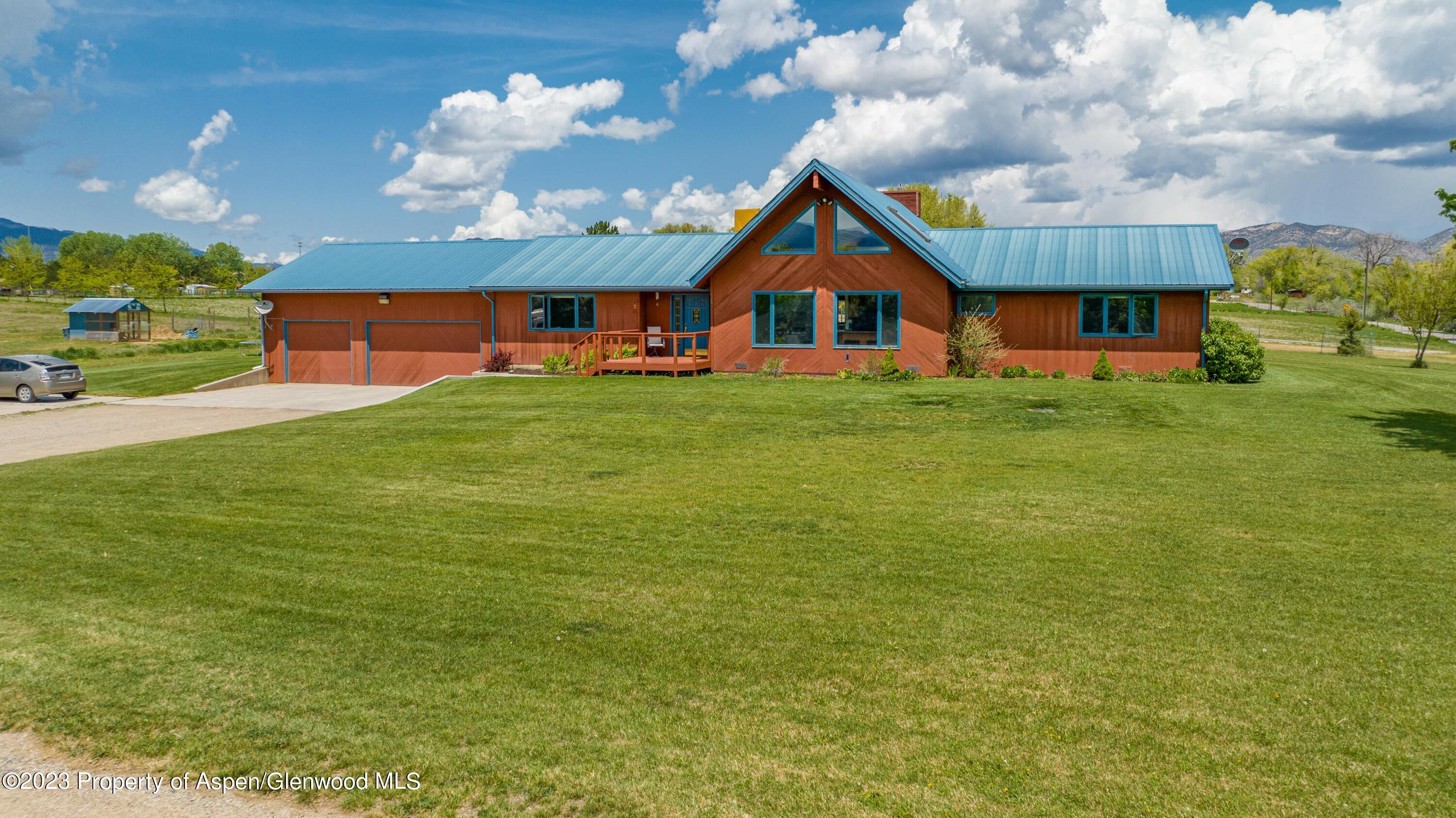 1840 County Road 293 Rifle, CO 81650 - Photo 3 of 27 a front view of a house with garden