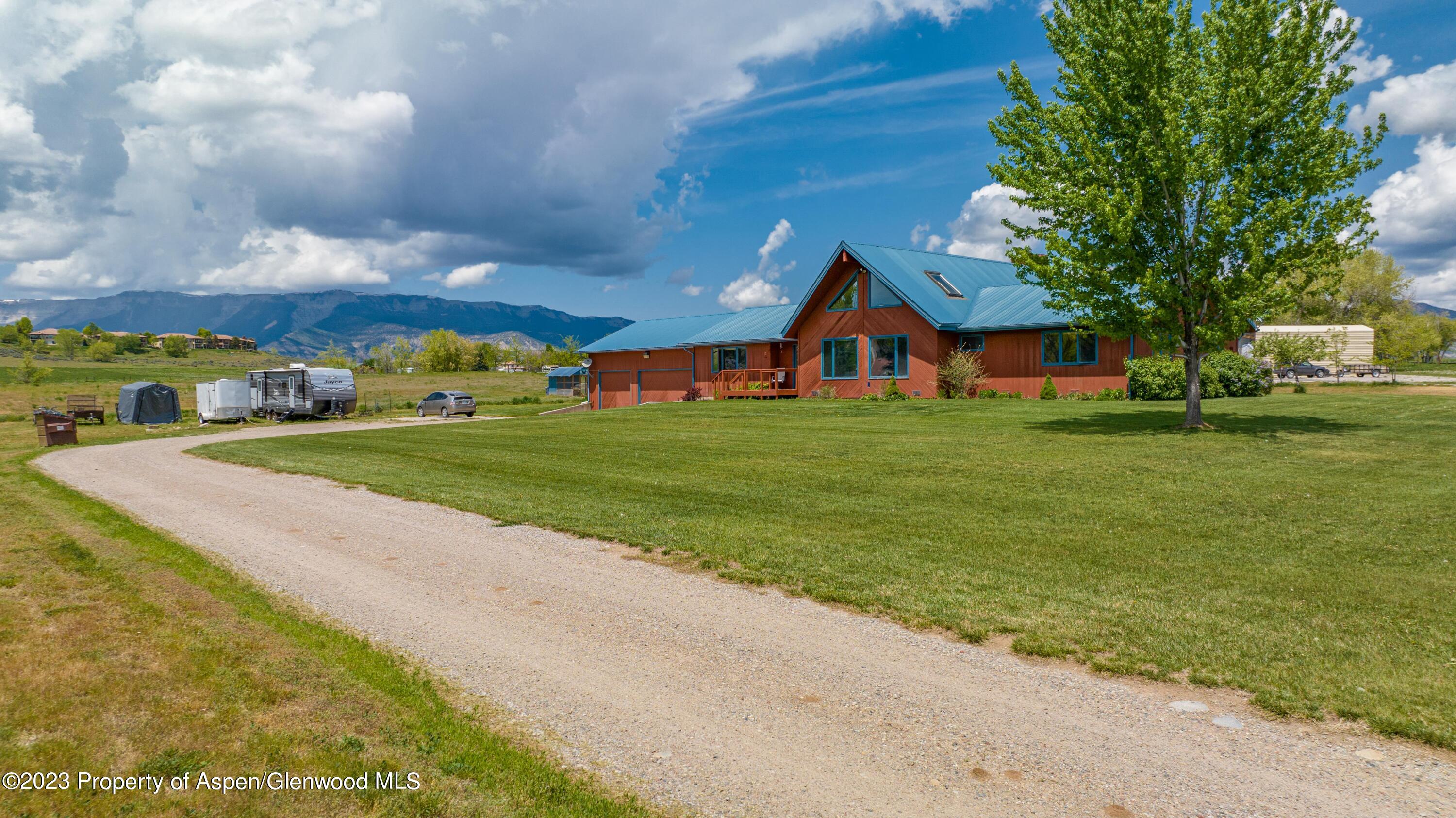 1840 County Road 293 Rifle, CO 81650 - Photo 4 of 27 a view of a house with a big yard and large trees