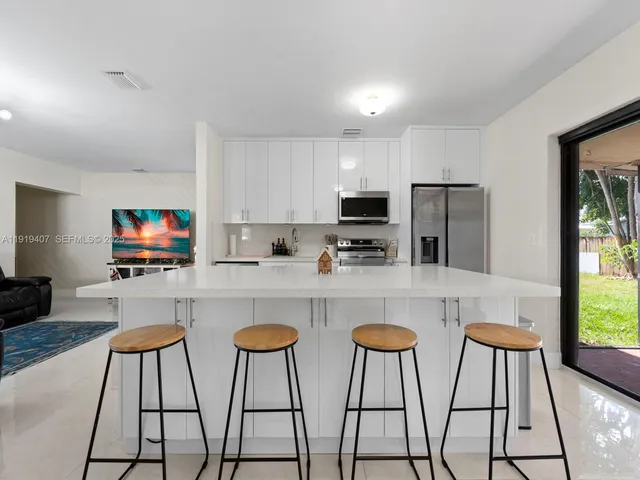 a kitchen with stainless steel appliances a stove a refrigerator and a microwave