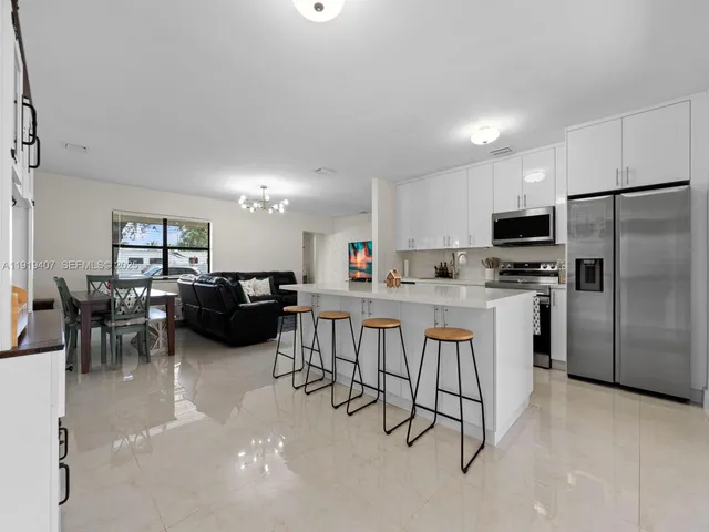 a kitchen with appliances a sink a counter top space and appliances