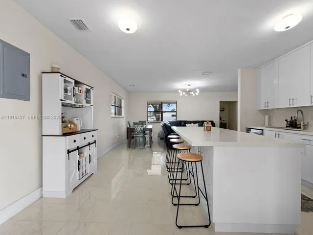 a kitchen with furniture a refrigerator and cabinets