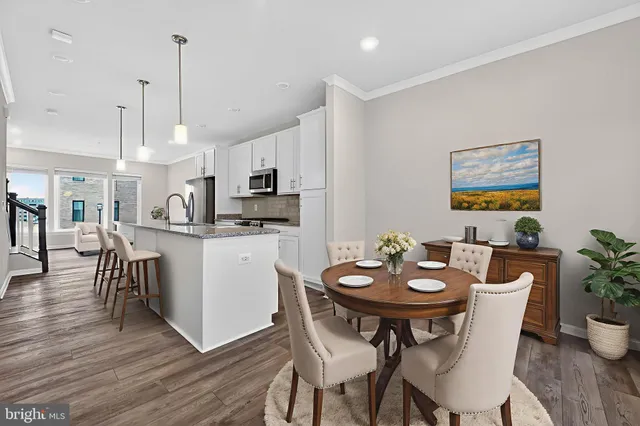 a kitchen with stainless steel appliances granite countertop a hardwood floor sink and stove