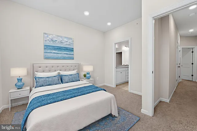 an empty room with a bathroom and windows