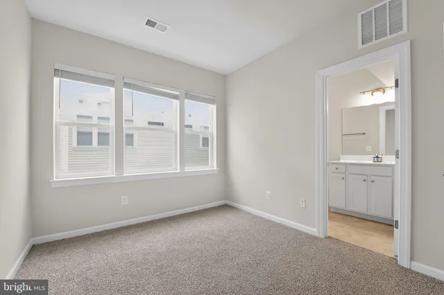 a bedroom with a bed and potted plant