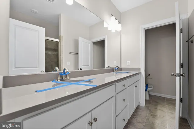 a bathroom with a sink toilet vanity and tub