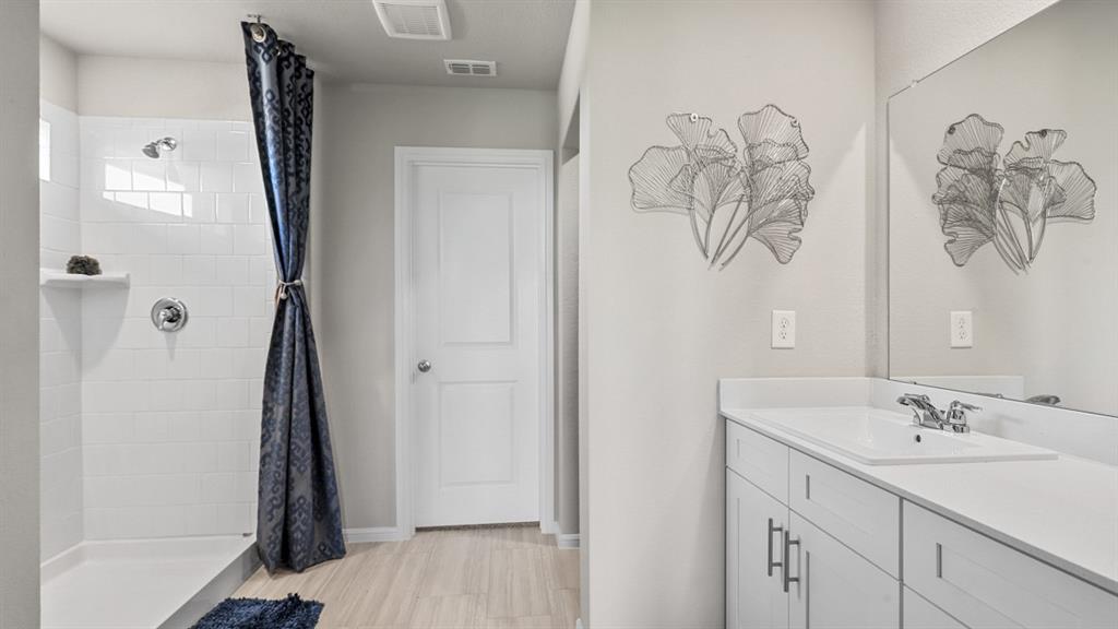 529 Marsh Street Cleburne, TX 76033 - Photo 18 of 39 a bathroom with a sink and mirror