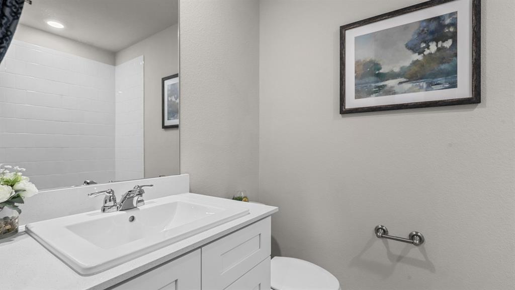 529 Marsh Street Cleburne, TX 76033 - Photo 28 of 39 a bathroom with a toilet a sink and mirror