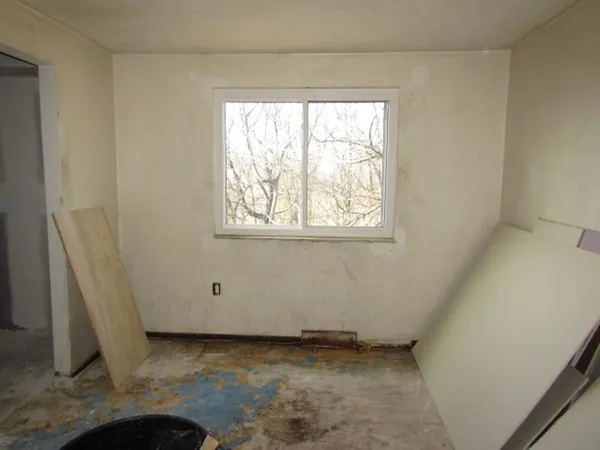 a room that has a rug and a window in it